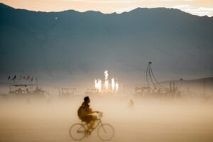 A person riding a bike into the horizon.