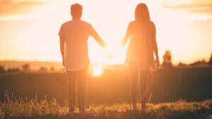 man and woman holding hands white facing sunset... Hope... Dreams.